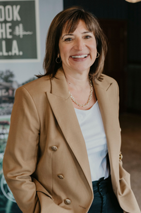 Portrait of Denise Schultz, Managing Director - Woods to Water Vacation Homes.